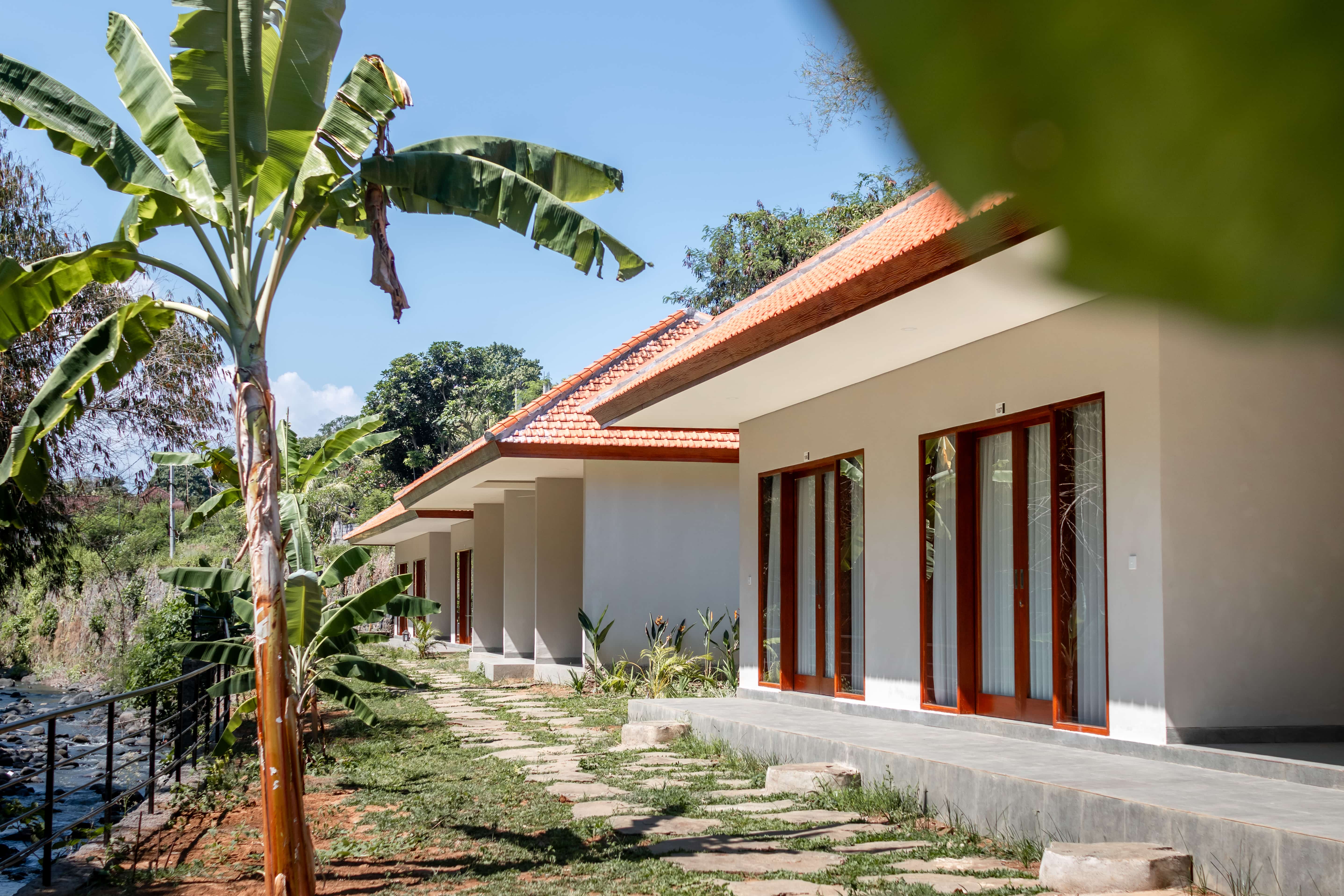 swimming pool with 2 sun loungers in Bali Vinyasa Yoga School 